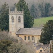 Old stone church in the country surrounded by trees.